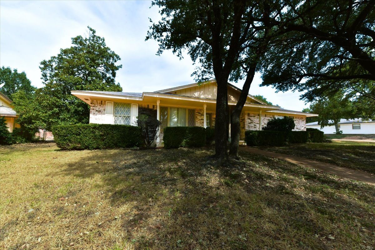 A house with a tree in front of it.
