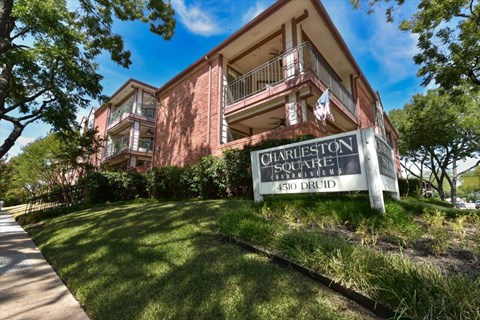 A brick building with a sign that says Charleston Square.