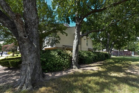 A house is surrounded by trees and greenery.