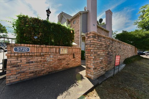 A brick wall with a sign that reads 5720.