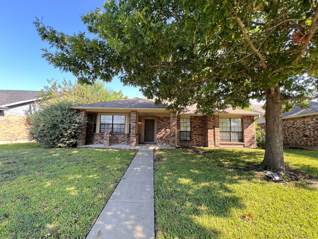 A house with a tree in front of it.