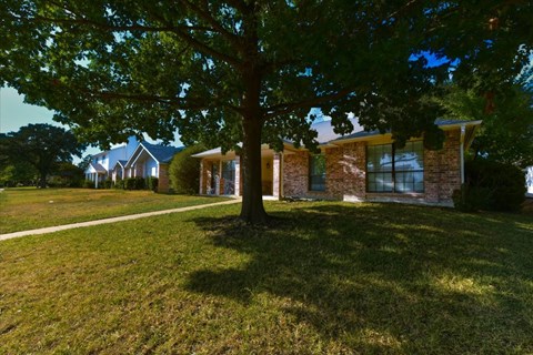 A house with a tree in front of it.