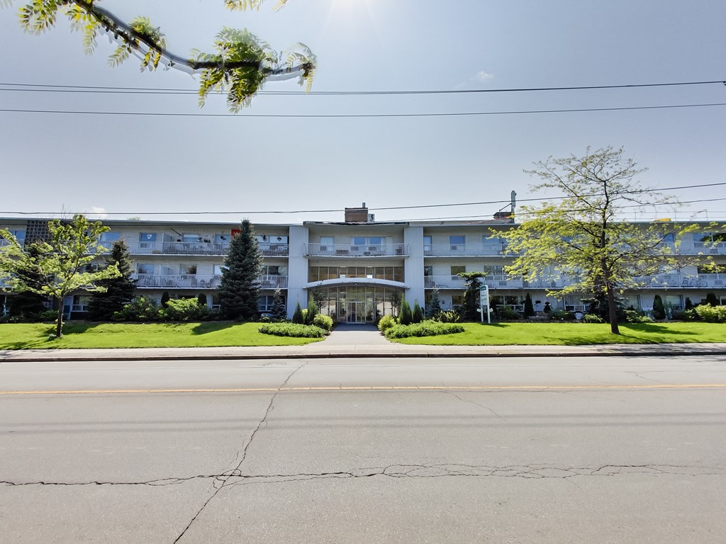 a large white building with a street in front of it