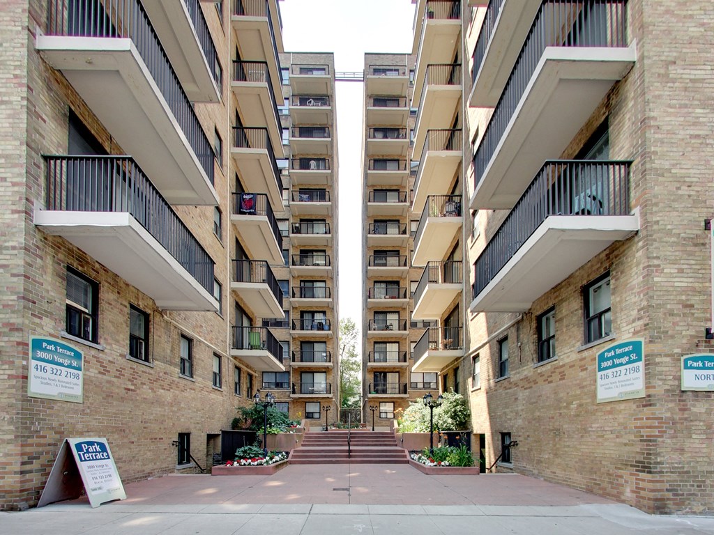 an empty street in front of an apartment building