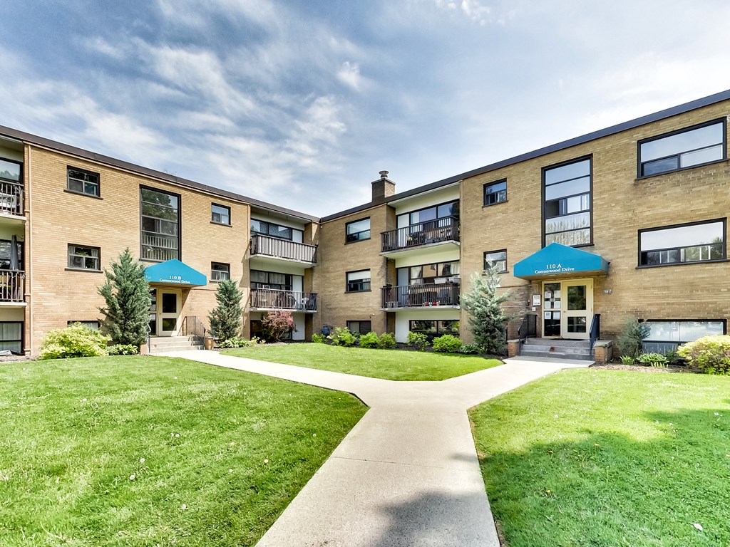 A sunny day at a residential complex with a clear blue sky.
