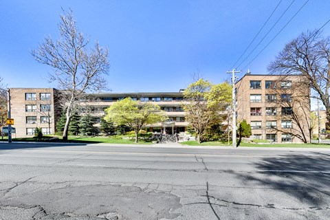 a view of an apartment building on the corner of a street