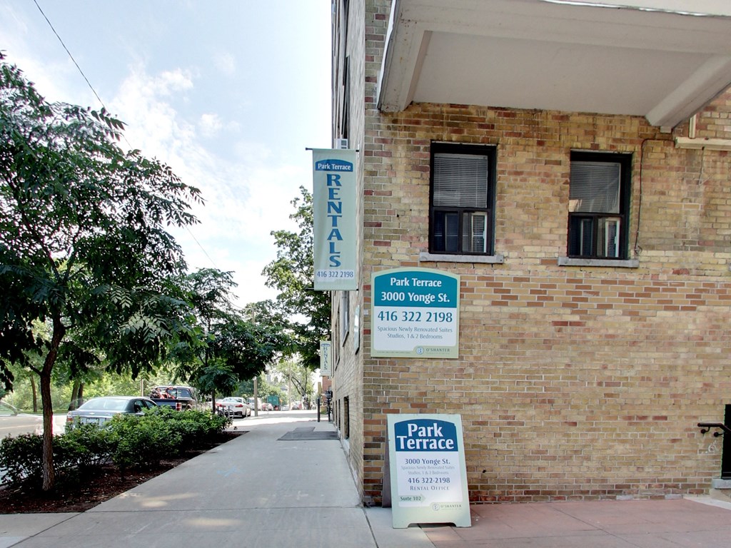 a brick building with a park terrace sign on the side of it