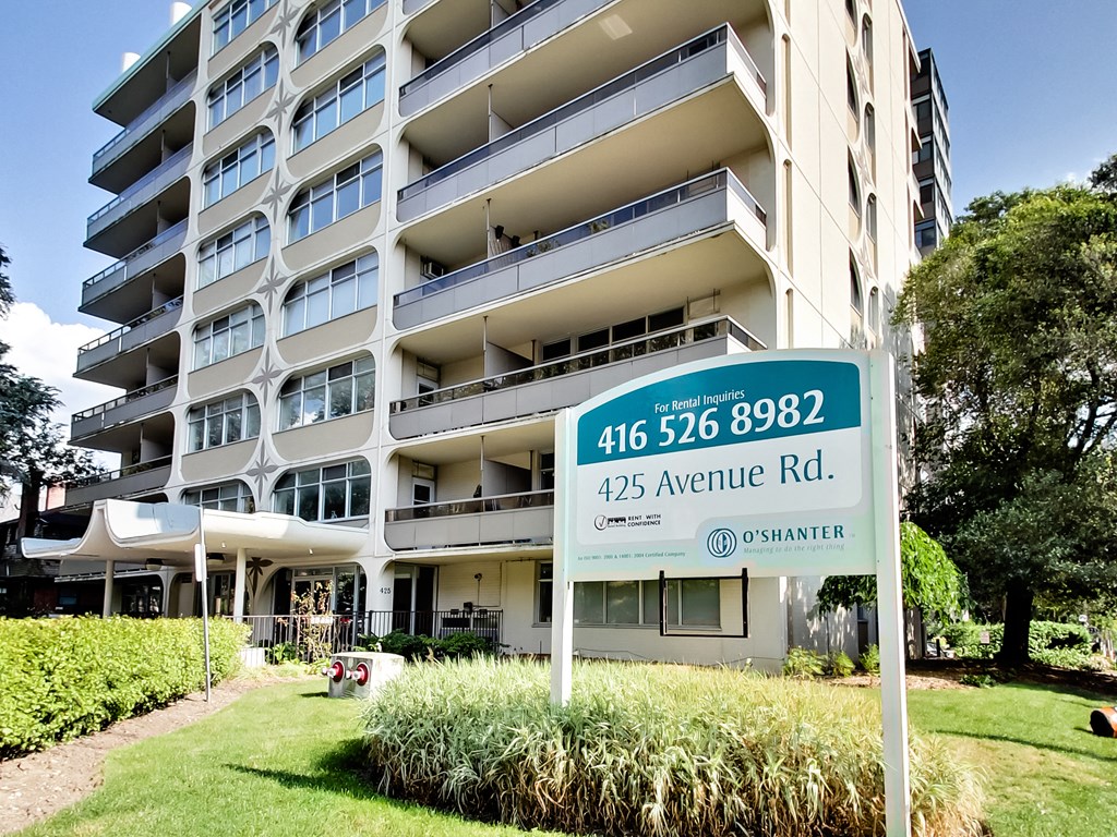 A large apartment building with a sign in front of it.