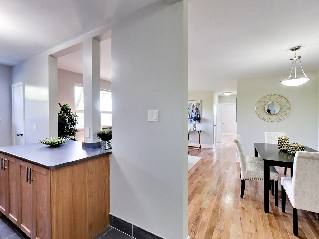 A kitchen with wooden cabinets and a black countertop.