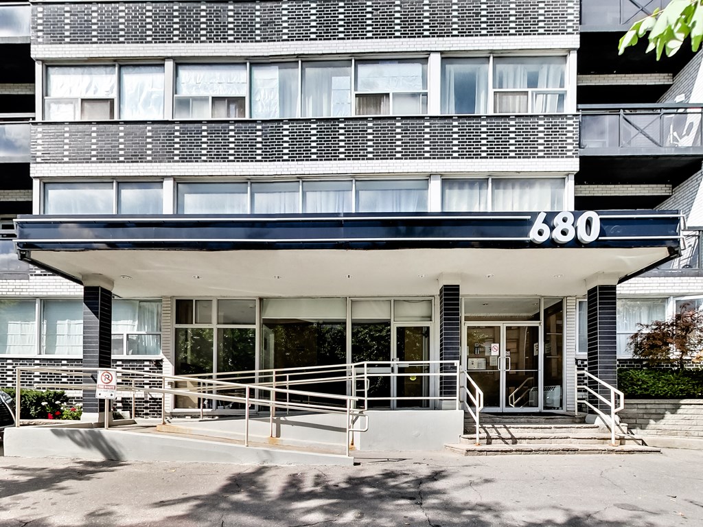 the facade of a building with a spiral staircase in front of it