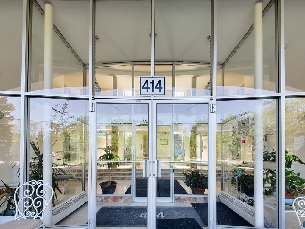 the entrance of a building with glass doors and windows