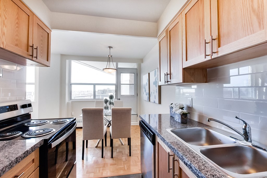 A kitchen with wooden cabinets and a black stove top oven.