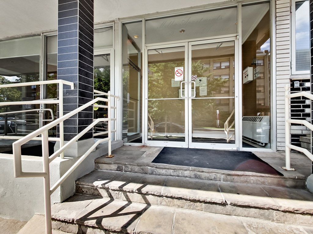 the entrance to a building with glass doors and stairs