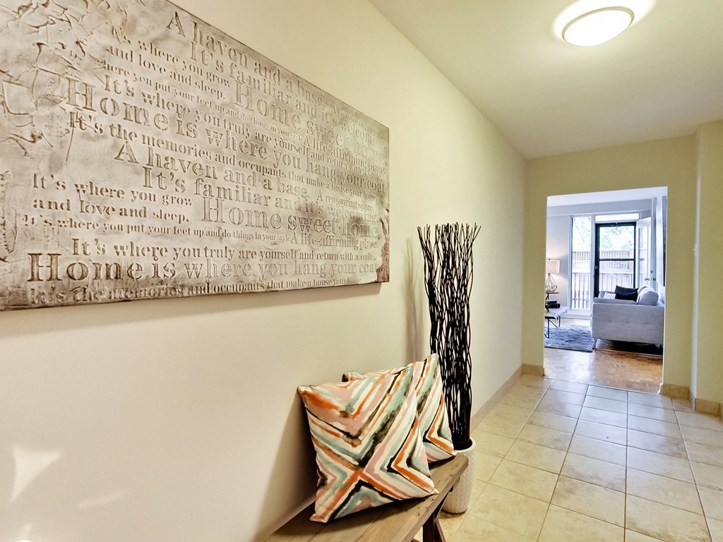 the living room of a house with a painting on the wall