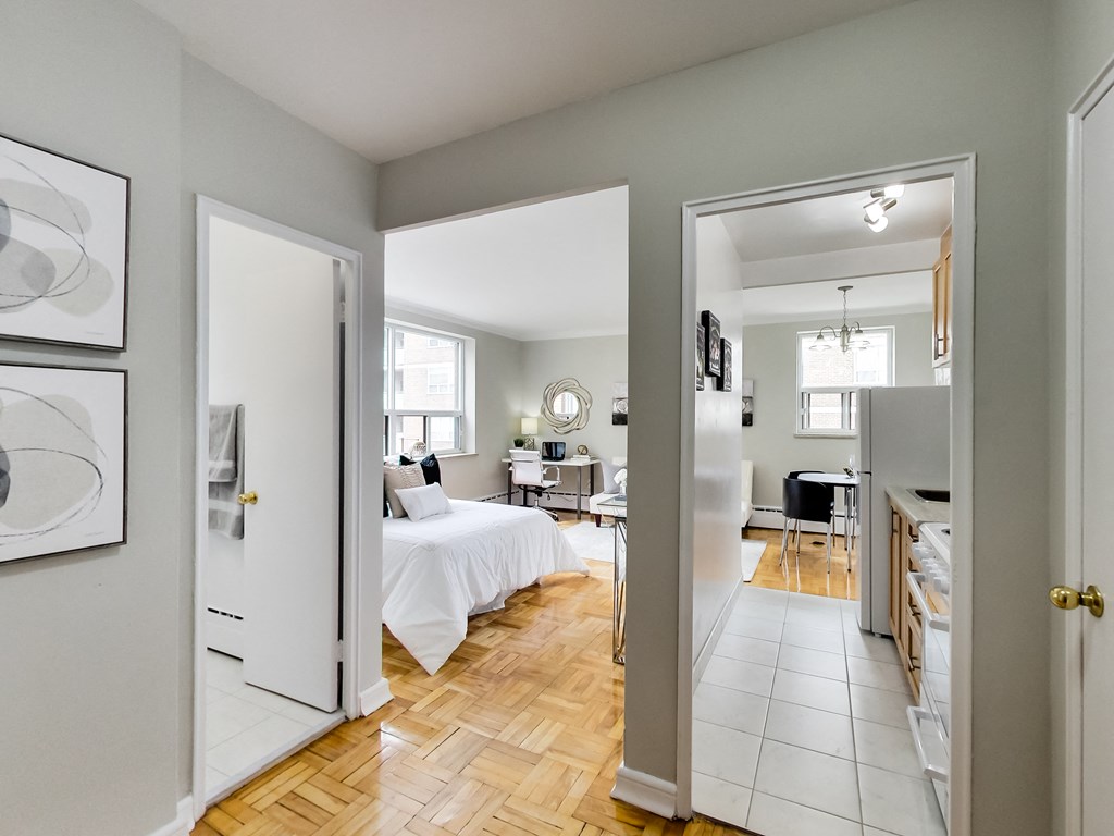 a bedroom and a living room with a bed and a kitchen