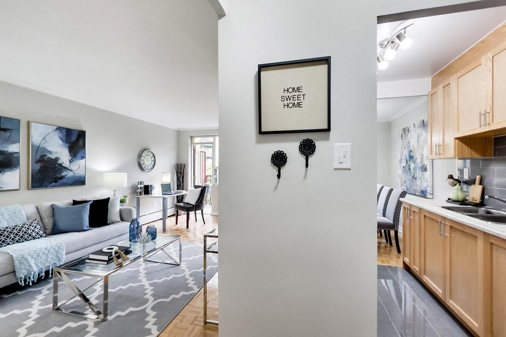 a living room and kitchen with a couch and a table