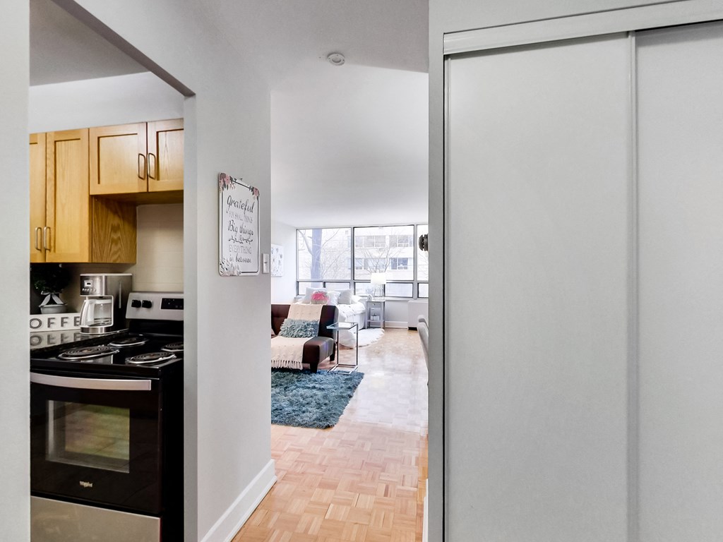 A kitchen with a stove top oven and a white door.