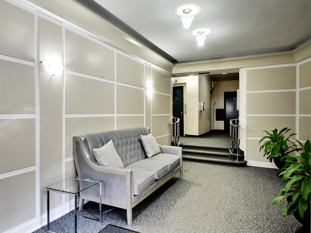 a living room with a couch and a glass table