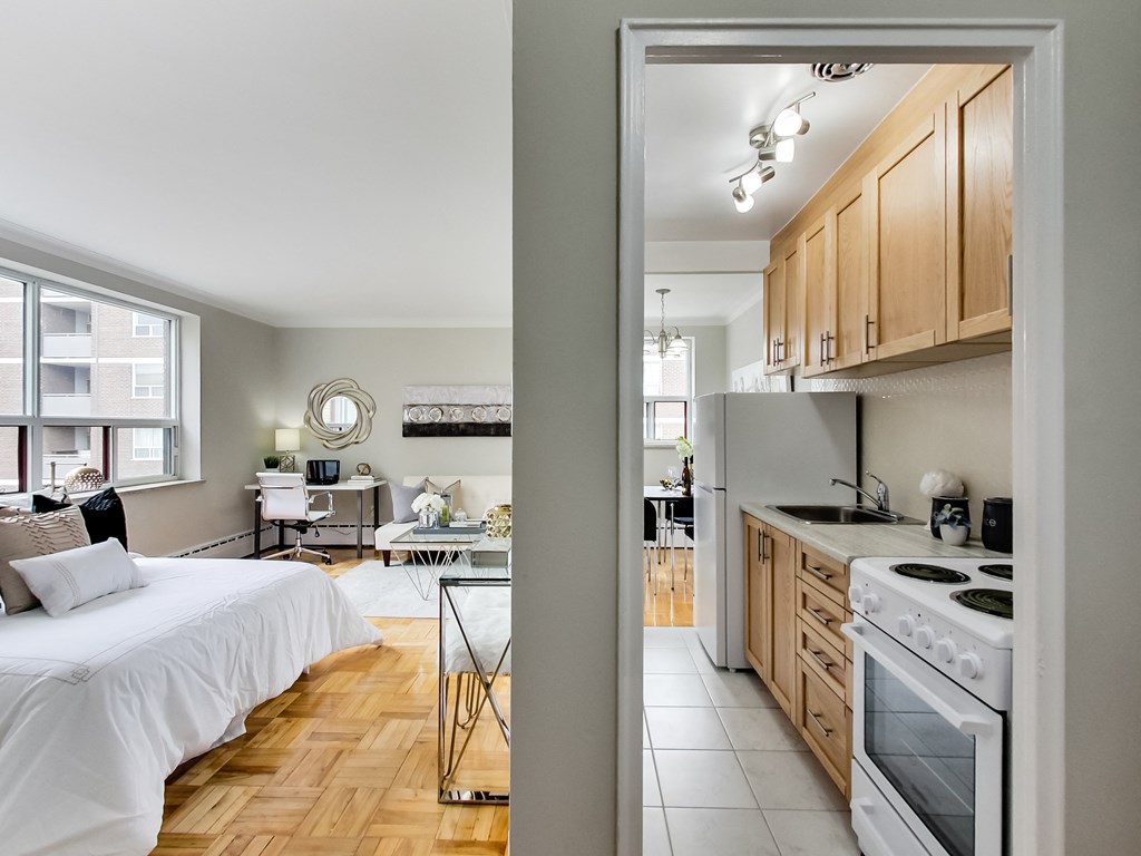 a view of a bedroom and a kitchen from a doorway