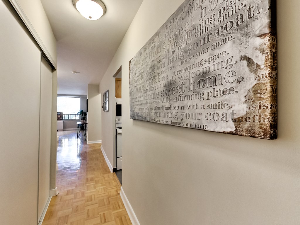 A hallway with a large piece of artwork on the wall.