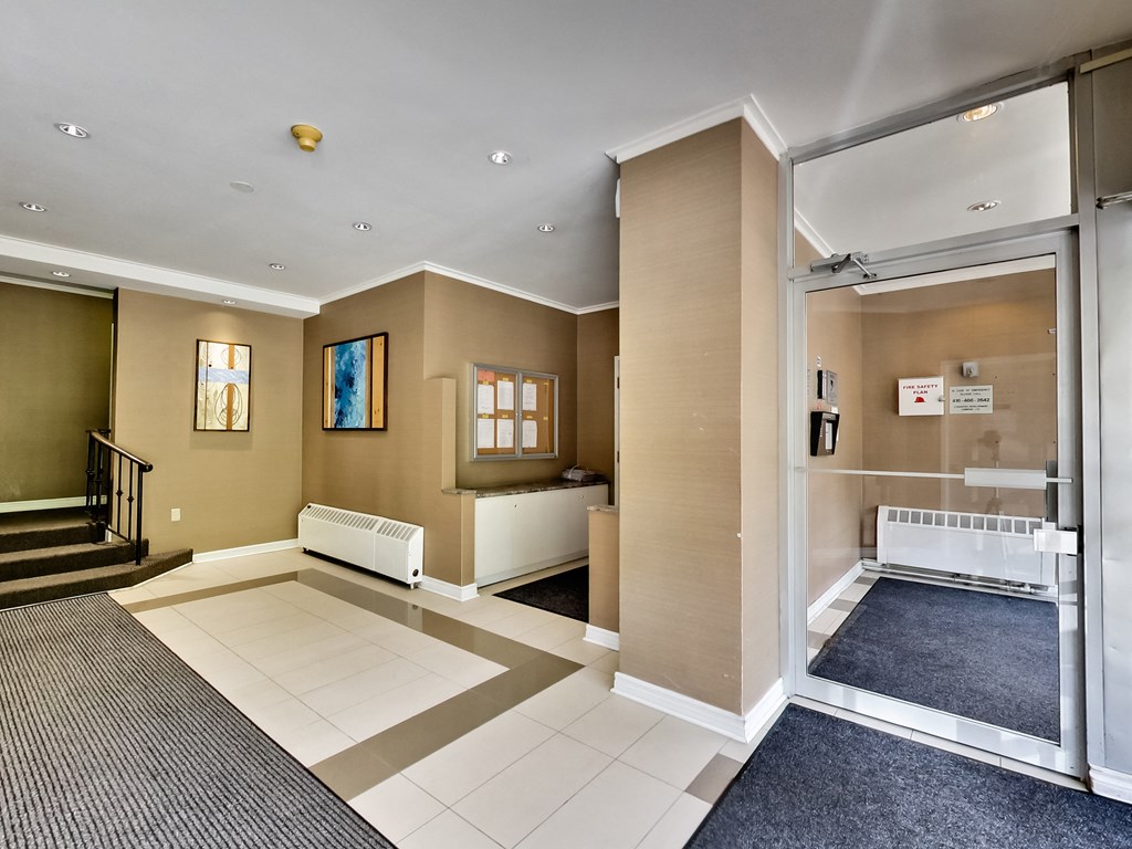 a view of a lobby with a baby crib and a glass door