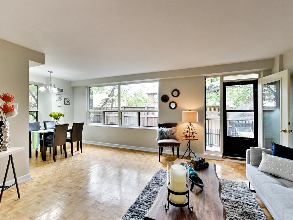 an open living room and dining room with a large window