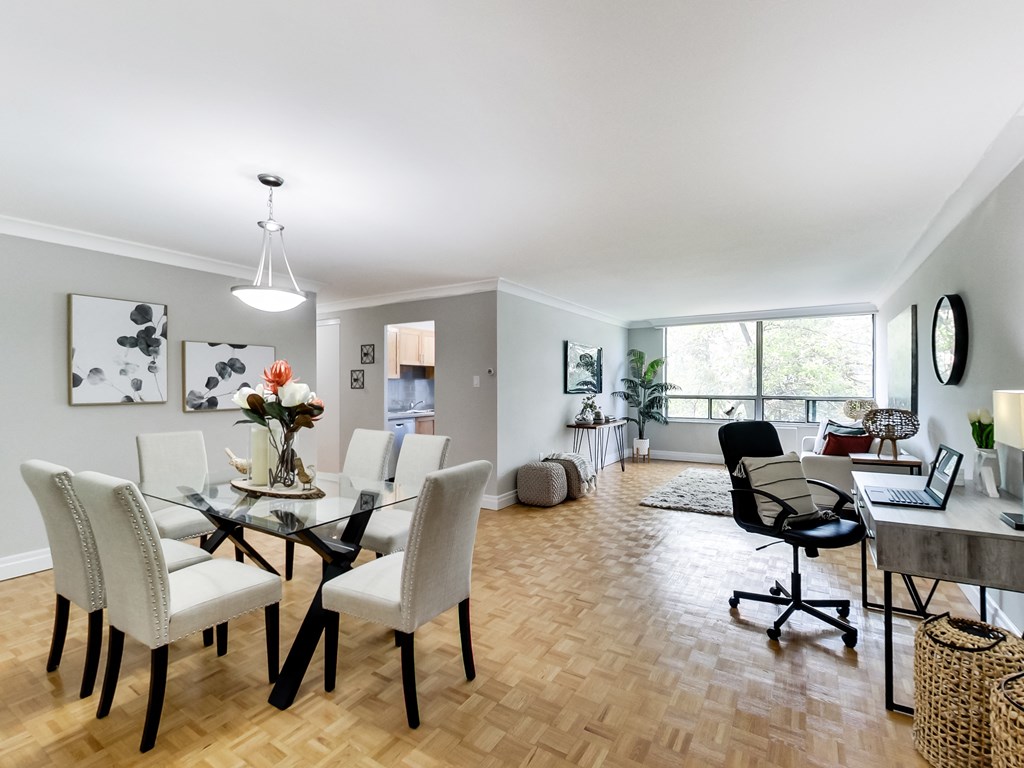 A dining room with a glass table and chairs.