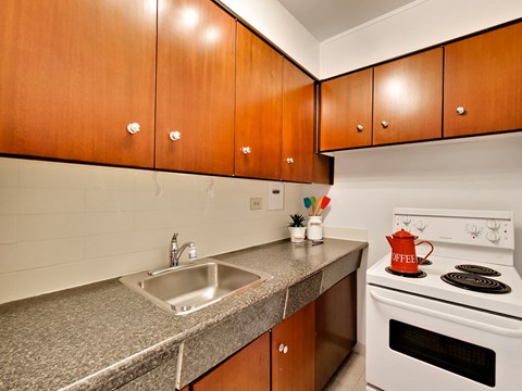 A kitchen with a white stove and a sink.
