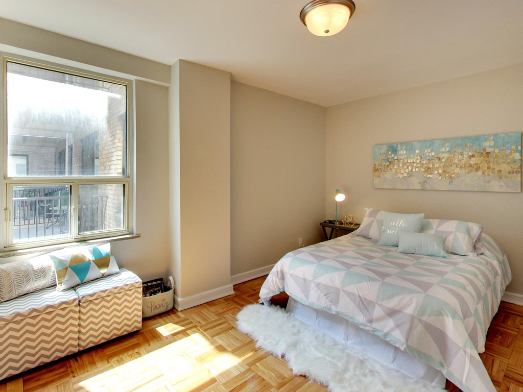 a bedroom with a bed and a window