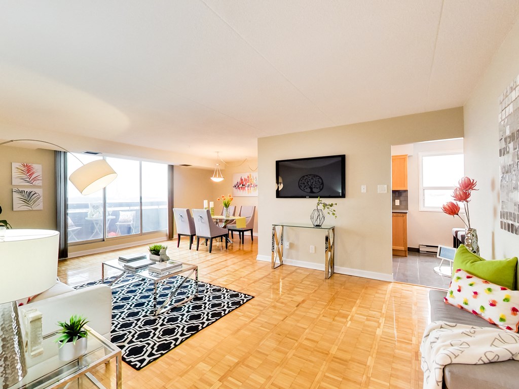 a living room with a table and chairs and a large window