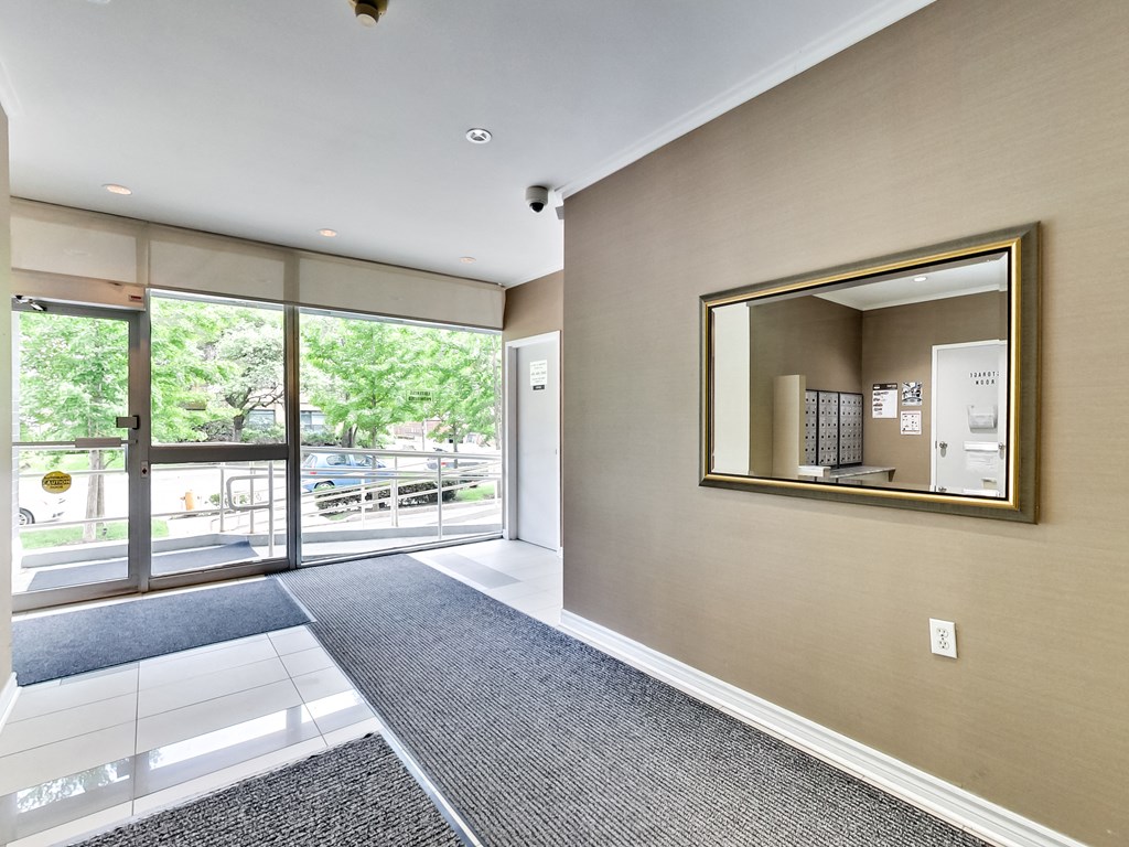 a large mirror in the center of a room next to a door