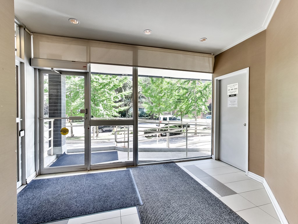 a lobby with glass doors and a view of a parking lot