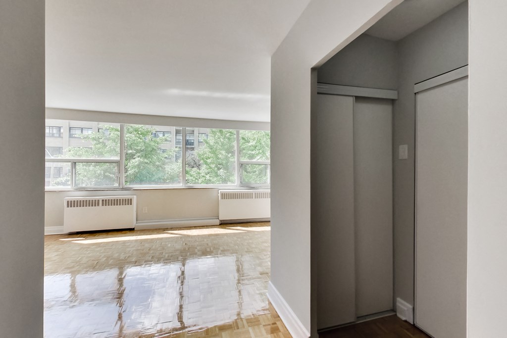 a living room with a large window and a door