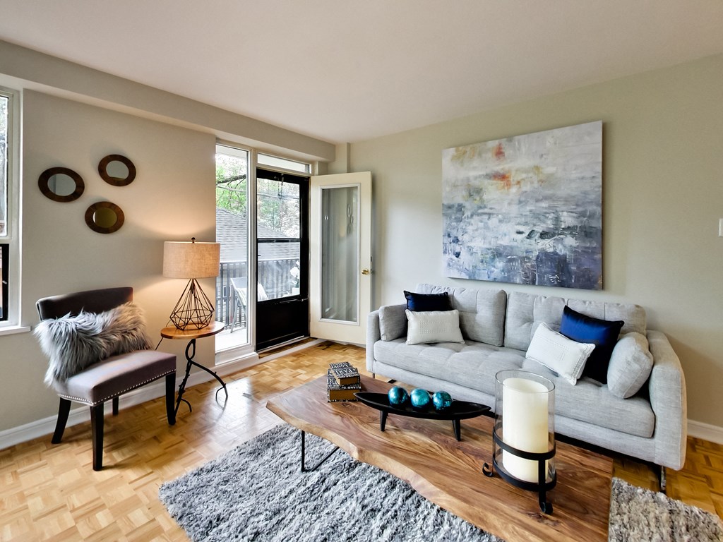 a living room with a couch and a chair and a table