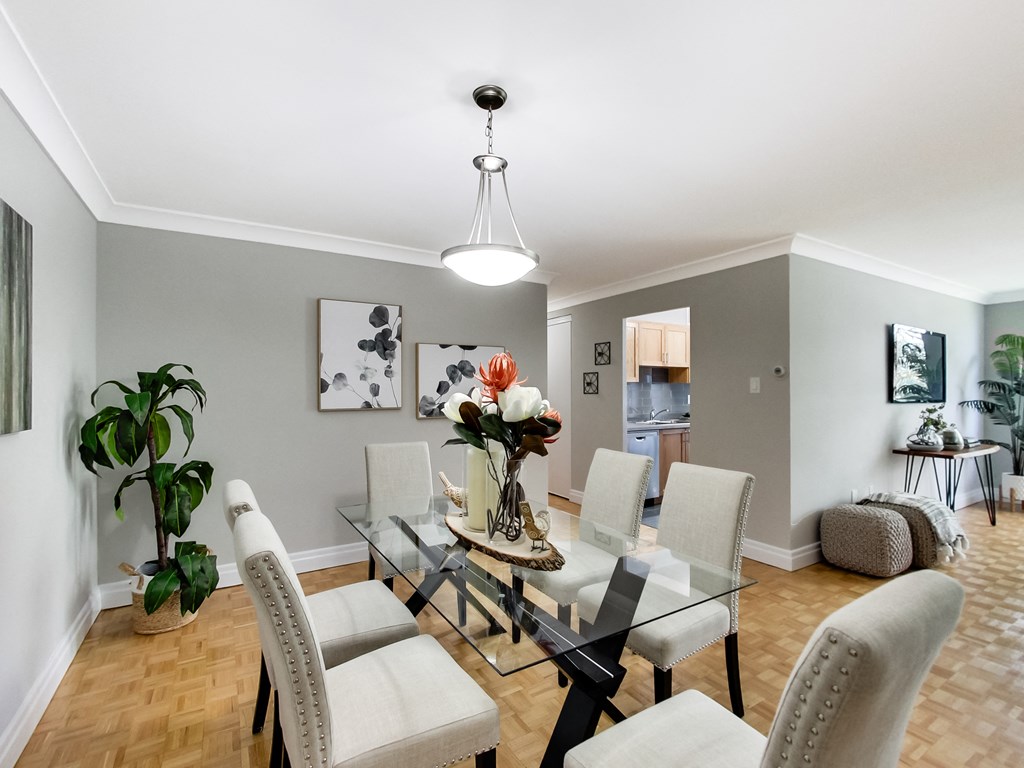 A dining room with a glass table and chairs.