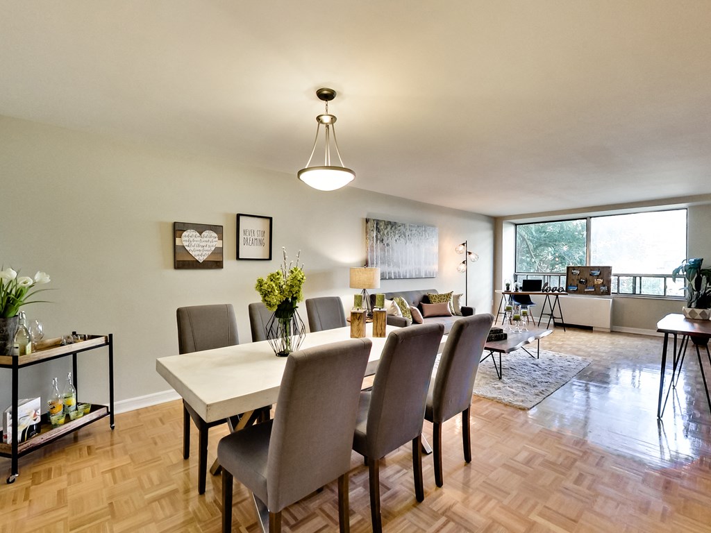 A dining room with a table and chairs.