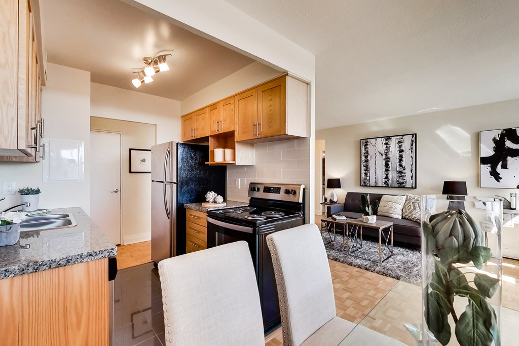 A modern kitchen with a refrigerator, stove, and oven.