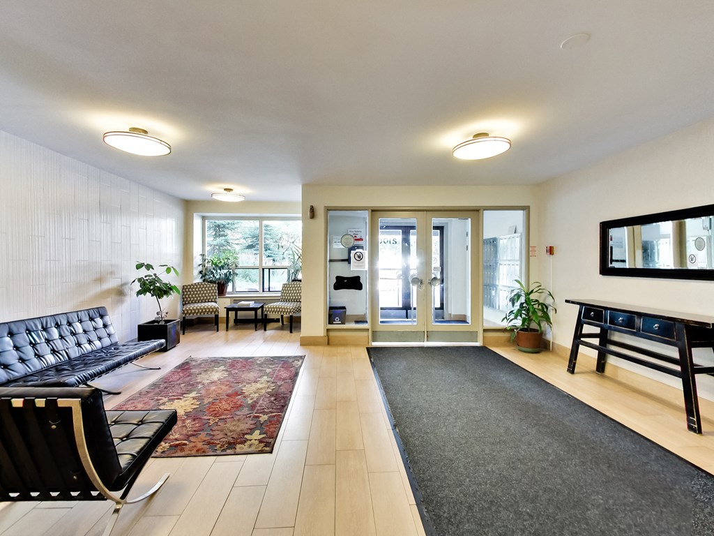 a living room with a piano and a rug
