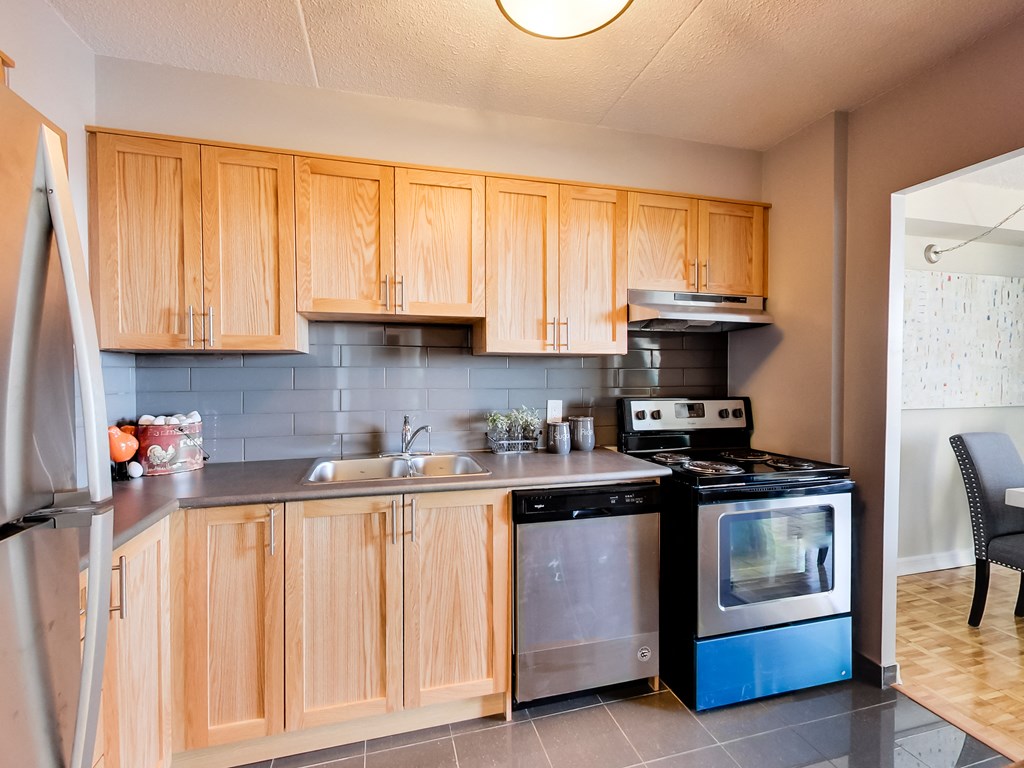 a kitchen with wooden cabinets and stainless steel appliances