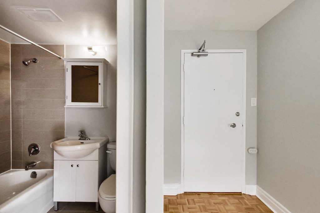 a bathroom with a sink toilet and shower and a mirror