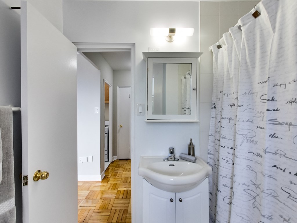a bathroom with a sink and a shower curtain