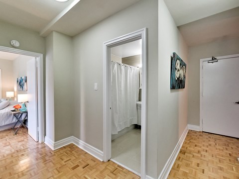 a renovated living room with a sliding glass door to a bathroom and a bedroom with