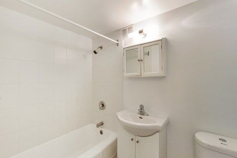 a bathroom with a sink and a bath tub and a toilet