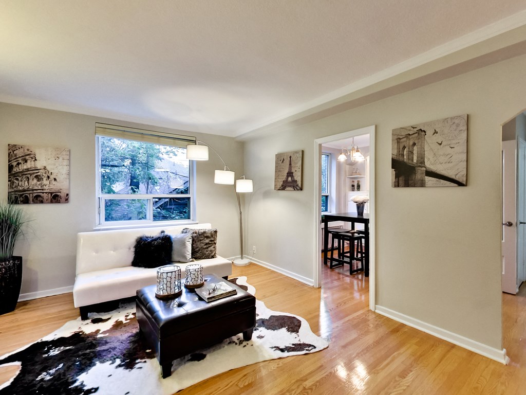 a living room with a couch and a table in front of a window