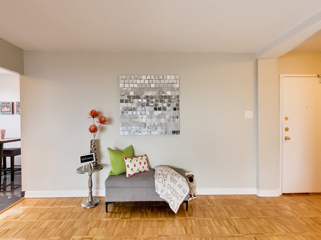 a living room with a couch and a painting on the wall