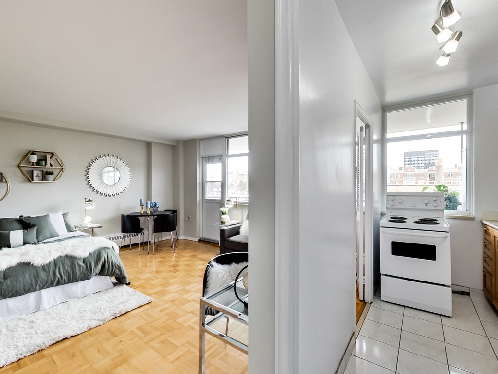 A bedroom with a bed and a chair in it.