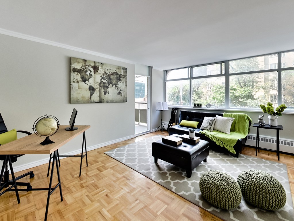 A living room with a green couch and a wooden table.
