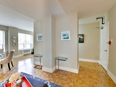 a living room with a hard wood floor and white walls