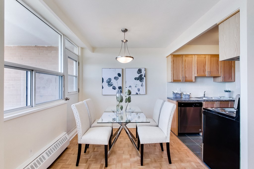 A kitchen with a table and chairs in the middle of the room.