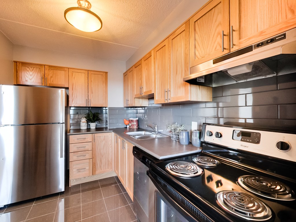 a kitchen with stainless steel appliances and wooden cabinets